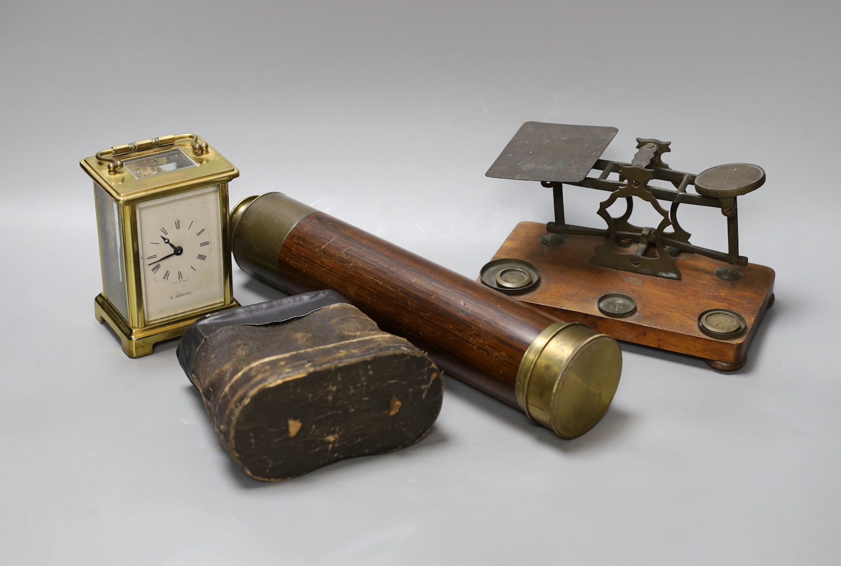 A five draw telescope, a pair of cased binoculars, postal scales and a brass timepiece, telescope drawn 69 cms long